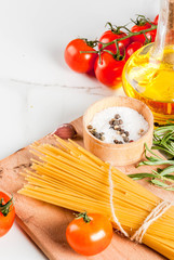 Italian food cooking, ingredients for preparation pasta spaghetti - tomato, garlic, olive oil, spices, white marble background, copy space