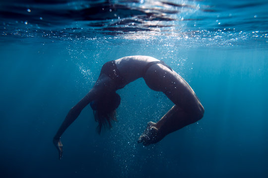 Woman floating underwater