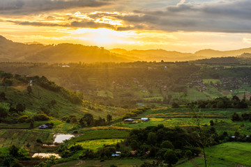 Aerial scenery view of sunrise over mountain range at rural village. Location in Khao Kho District, Phetchabun, Thailand, Southeast Asia.