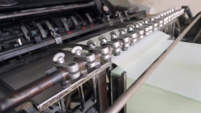 Process of Offset Print on Vintage Old Printing Conveyor Machine in Retro Style Typography. 4K.
