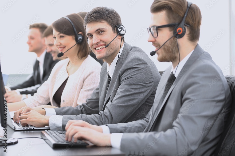 Wall mural employee call center with headset at workplace