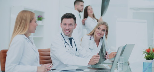 Obraz premium Smiling doctors working at office desk and smiling at camera, me