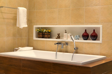 Brown bathroom including bath