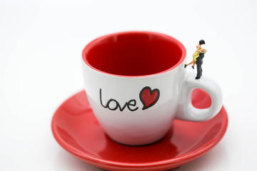 Miniature people : Couple Lover standing with cup off coffee, lovely concept.