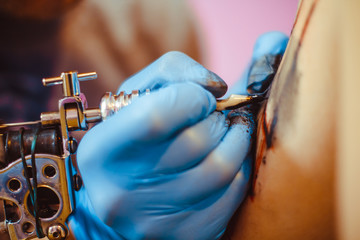 The master does the tattoo
