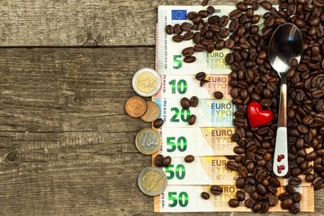 Roasted coffee beans and valid euro banknotes. Coffee trading. Sale of commodities.