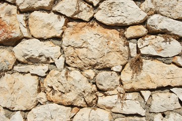 Genoese fortress wall fragment.  Old stonewall. Textured background. Rocks and concrete. 