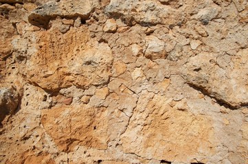 Genoese fortress wall fragment.  Old stonewall. Textured background. Rocks and concrete. 