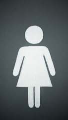 A lady toilet sign on the green wall background
