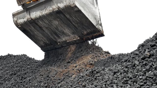 Black natural charcoal used as fuel for industrial plant. Loading of coal with a hydraulic gripper