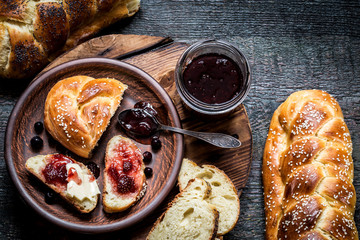 Challah is a Jewish bread to the feast on the dark wooden boards.