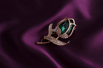 gold brooch rose bud with emerald and diamonds on silk