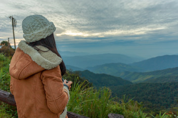 Fototapeta na wymiar Photographer taking photo of landscape from top of the mountain