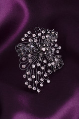 brooch with diamonds isolated on silk