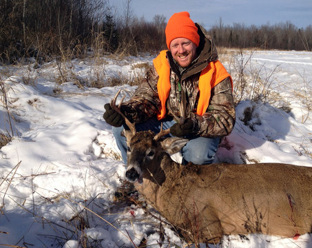 Wisconsin deer hunter with a Whitetail Buck