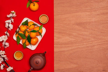 Overhead of top decorations Chinese New Year festive background concept.Mix variety essential accessory on modern grunge brown table house office desk.Other language mean rich or wealthy and happy.