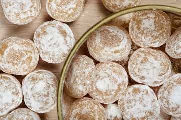 Candies sprinkled with powdered sugar in a metal jar.