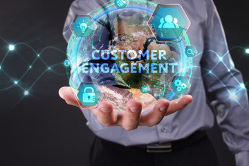 The concept of business, technology, the Internet and the network. A young entrepreneur working on a virtual screen of the future and sees the inscription: Customer engagement