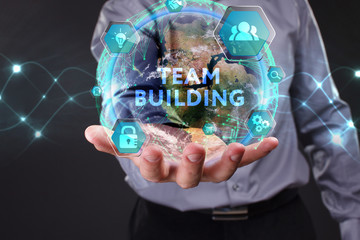 The concept of business, technology, the Internet and the network. A young entrepreneur working on a virtual screen of the future and sees the inscription: Team building