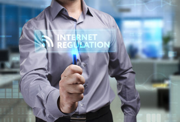 The concept of business, technology, the Internet and the network. A young entrepreneur working on a virtual screen of the future and sees the inscription: Internet regulation