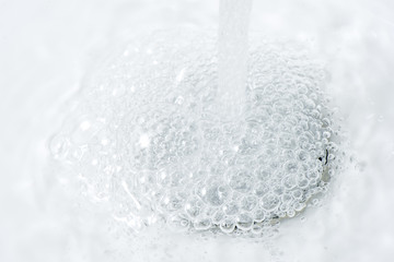 Close Up of Water Bubbles on Bathroom Sink Drain Hole