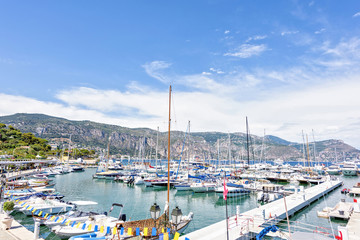 Fototapeta na wymiar Daylight sunny view to parked yachts in port of Beaulieu-sur-Mer in France
