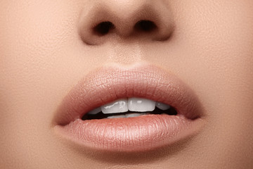 Natural fashion lipstick. Close-up beautiful sexy lips. Full lips with lip makeup. Filler...