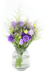 bouquet of violet roses on glass flower vase on white isolated background