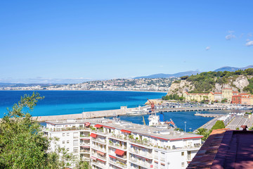 Daylight sunny view from roof to city buildings and bright blue sea