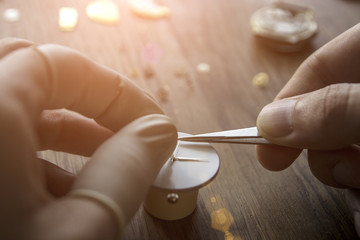 A watch maker is repairing a vintage automatic watch.