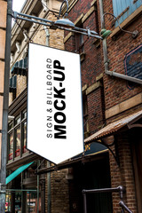 Obraz premium Mock up banner flag shape design hanging over on street