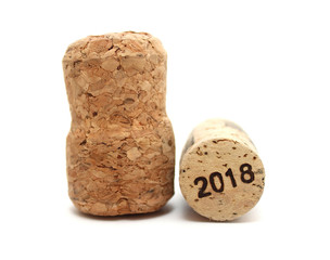 Cork from sparkling wine and cork from dry wine with date new 2018 year isolated on white background