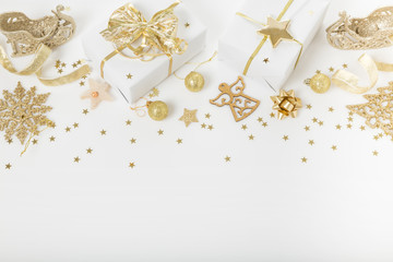 Christmas holiday composition. Festive creative golden pattern, xmas gold decor holiday ball with ribbon, snowflakes, christmas tree on white background.