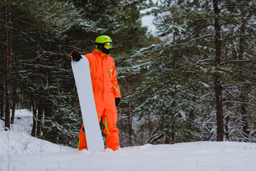 Snowboarder posing in winter forest