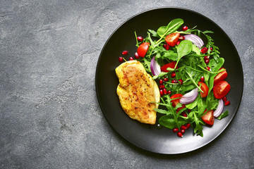 Grilled chicken breast with vegetable salad.Top view with copy space.