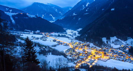 top view on snowy village luesen valley  at night south tirol Italy