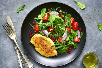 Grilled chicken breast with vegetable salad.Top view with copy space.