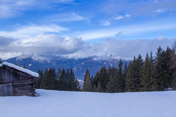 Obraz na płótnie Canvas South tirol snow mountains landscape and wood cabin winter travel