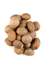 Pile of nutmeg seeds isolated on a white background
