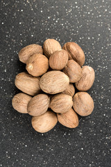 Pile of nutmeg seeds isolated on a black background