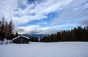 Fototapeta na wymiar South tirol snow mountains landscape and wood cabin winter travel