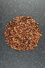 Pile of dried pomegranate seeds isolated on a black background