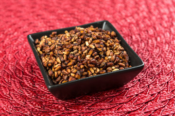 Pile of dried pomegranate seeds on a cloth background