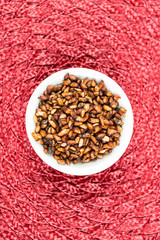 Pile of dried pomegranate seeds on a cloth background