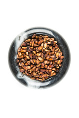 Pile of dried pomegranate seeds isolated on a white background