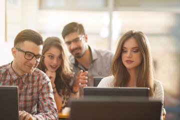 Group of university students are studying together in the computer lab