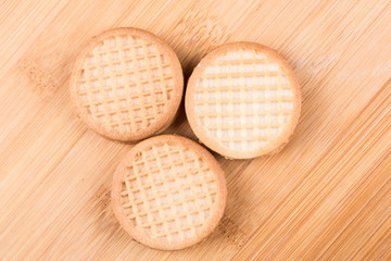 Stacks of cookies isolated on a wood background