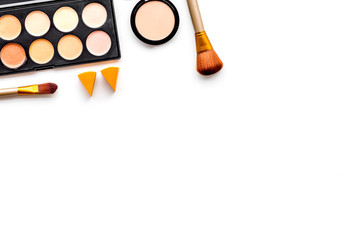 Professional bulk cosmetics. Eyeshadows, rouge, brushes on white background top view copyspace