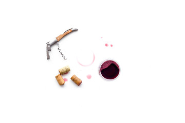 Traces of wine near corkscrew and glass of beverage on white background top view copyspace