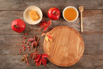 Composition with honey, apple and pomegranate for Rosh Hashanah holiday on wooden background, top view